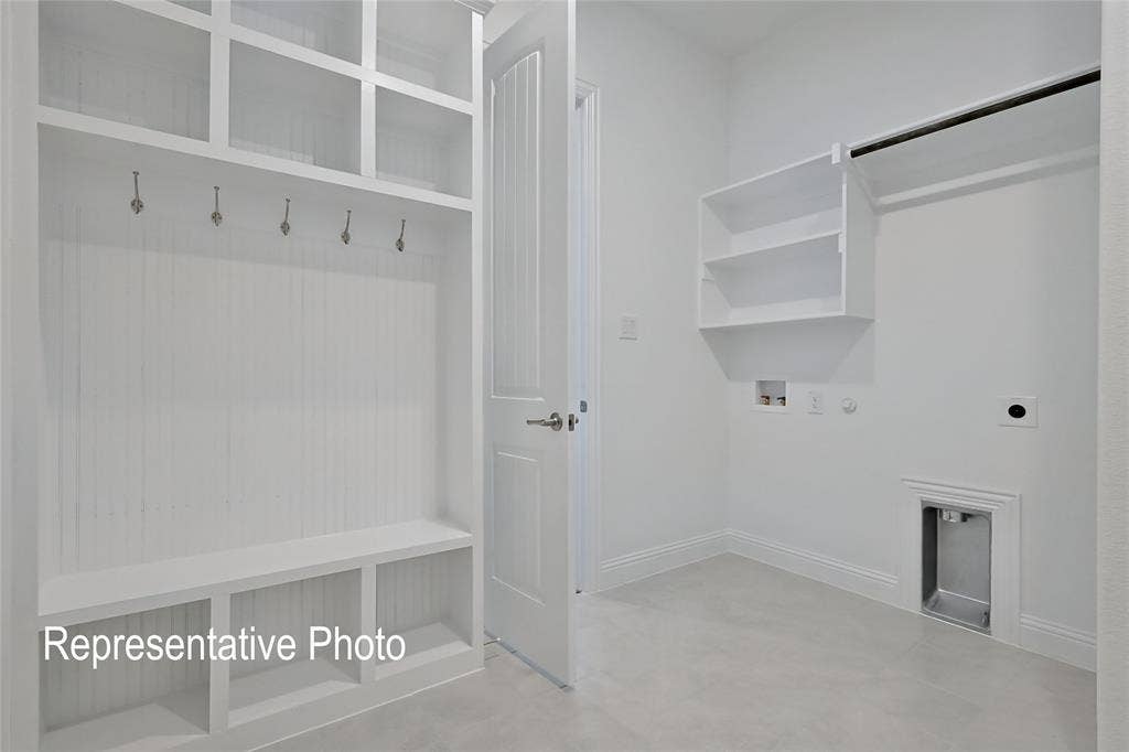 Entryway featuring a built-in mudroom bench with integrated shelving and coat hooks