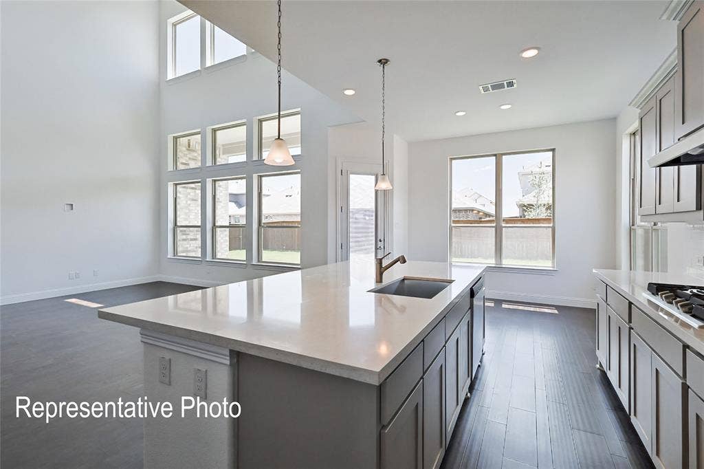 Kitchen island with a light-toned countertop and an undermount sink