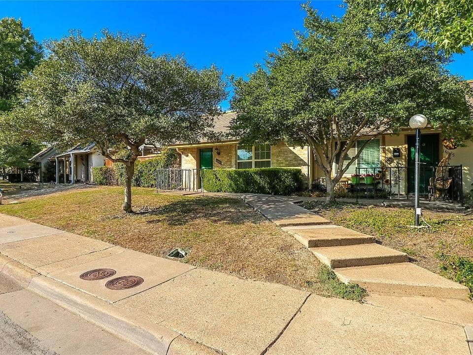 14003 Brookgreen Drive, Dallas, TX 75240 Brick facade residence with a green entry door