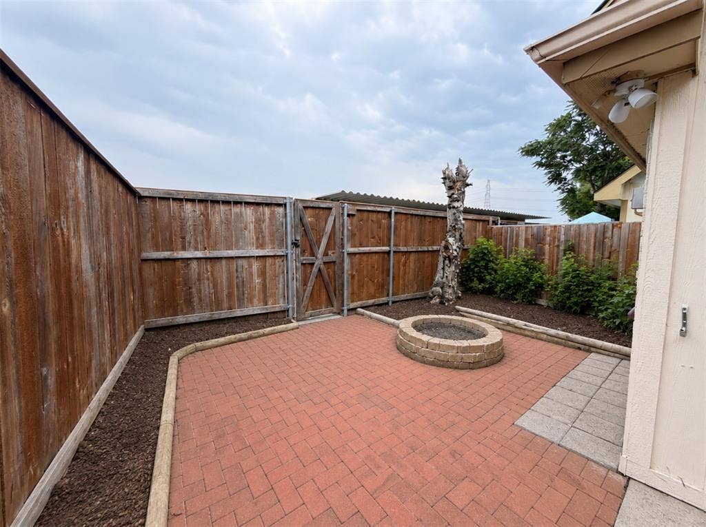 14003 Brookgreen Drive, Dallas, TX 75240 Brick paver patio featuring a built-in stone fire pit