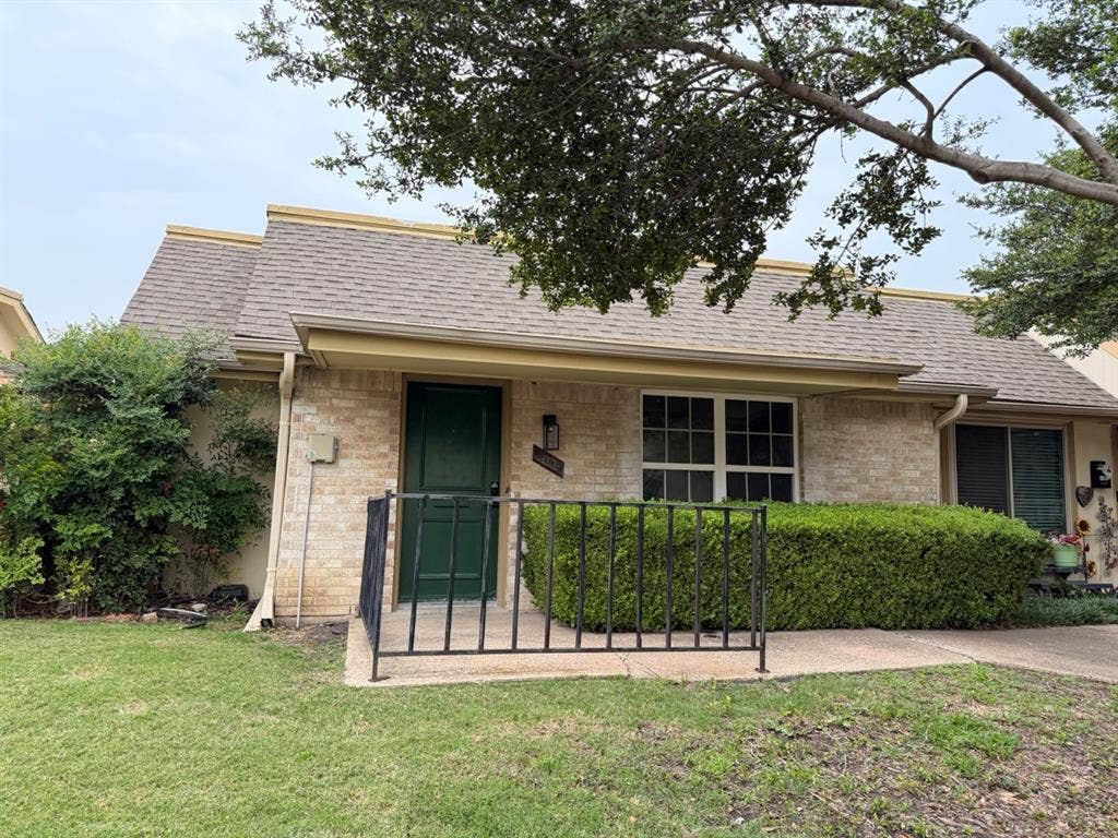 14003 Brookgreen Drive, Dallas, TX 75240 Brick exterior with a dark green entry door and contrasting light trim