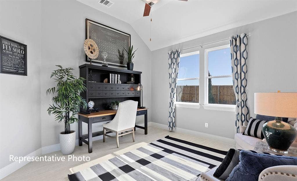 1140 Beaumont Lane, Red Oak, TX 75154 Room featuring vaulted ceilings with a ceiling fan, light-toned wood-finish flooring, and bright windows with white trim