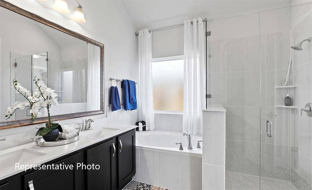 1140 Beaumont Lane, Red Oak, TX 75154 Bathroom featuring a double vanity with dark cabinetry, integrated dual sinks, and a large framed mirror