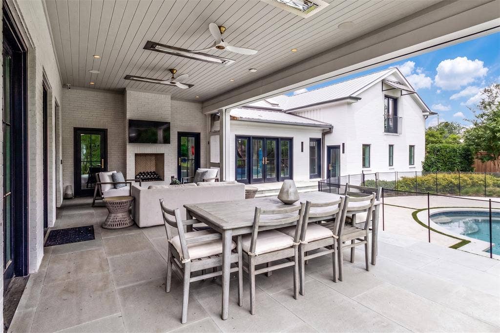Covered patio with fans, heaters, fireplace and phantom screens.
