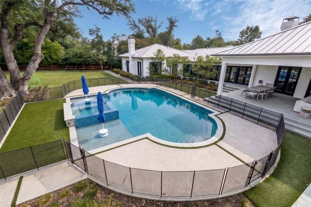 Over looking large backyard, pool, spa and patio.