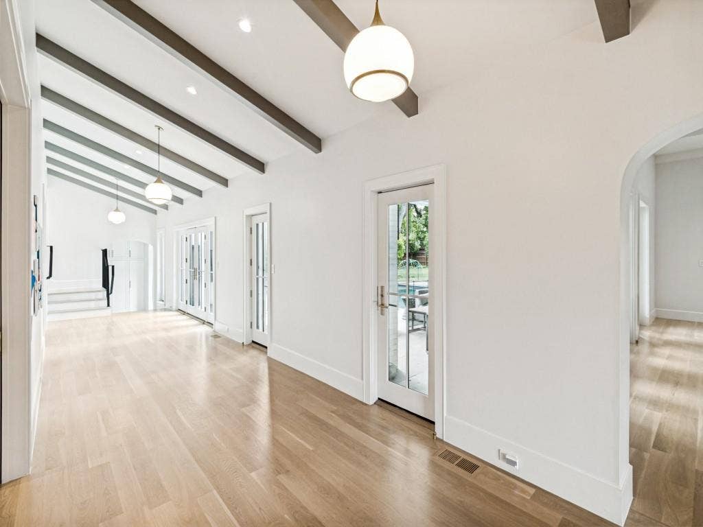 Hallway leading to pool bathroom, 2nd living room and stairs to 2 guest bedrooms.