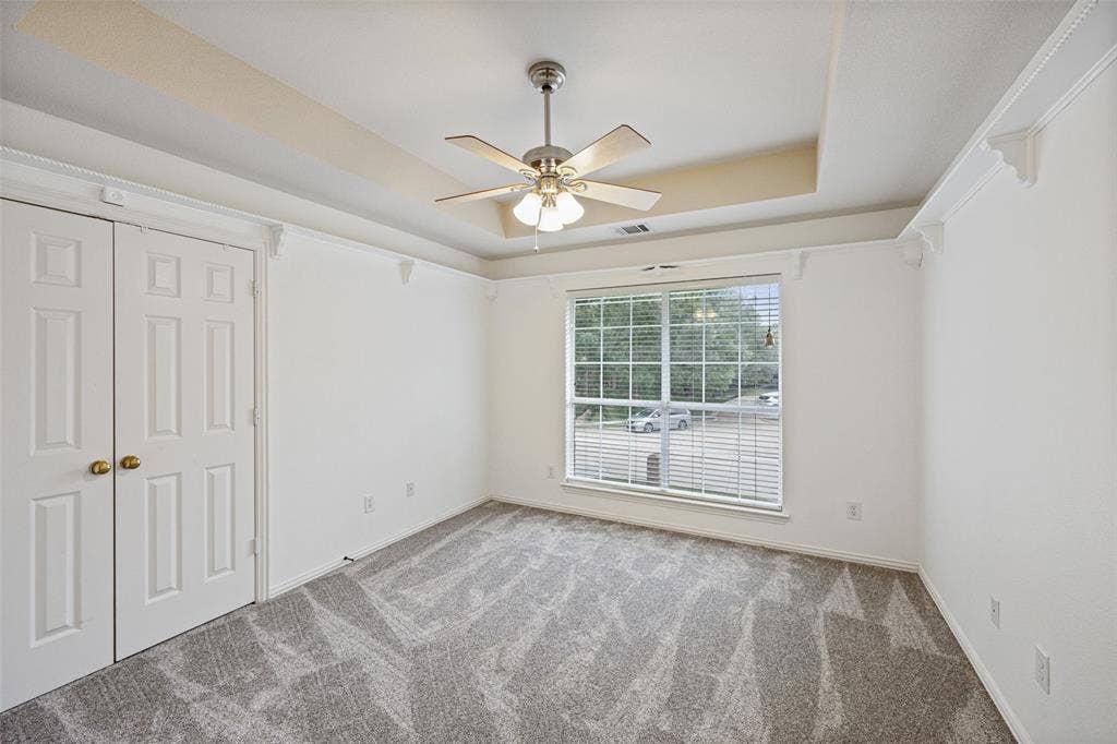 2701 Oates Drive, Plano, TX 75093 Room featuring a tray ceiling, ceiling fan with integrated lighting, and carpet flooring