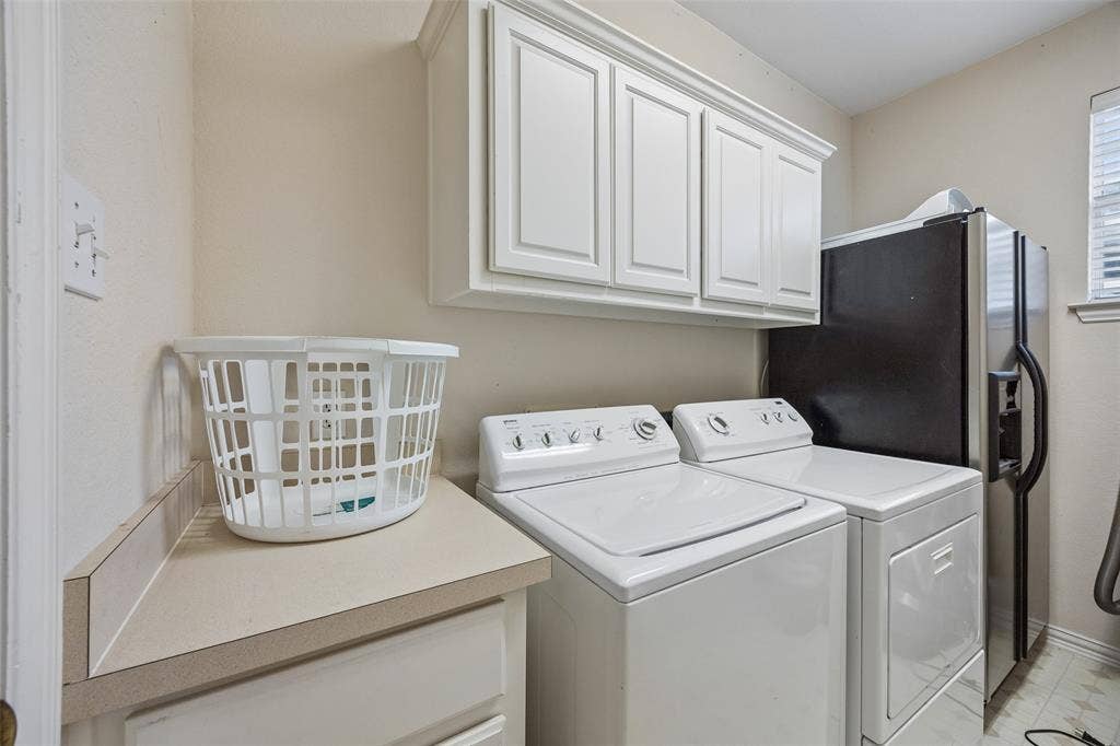 2701 Oates Drive, Plano, TX 75093 Utility area featuring upper cabinetry, a light-toned countertop, and a window