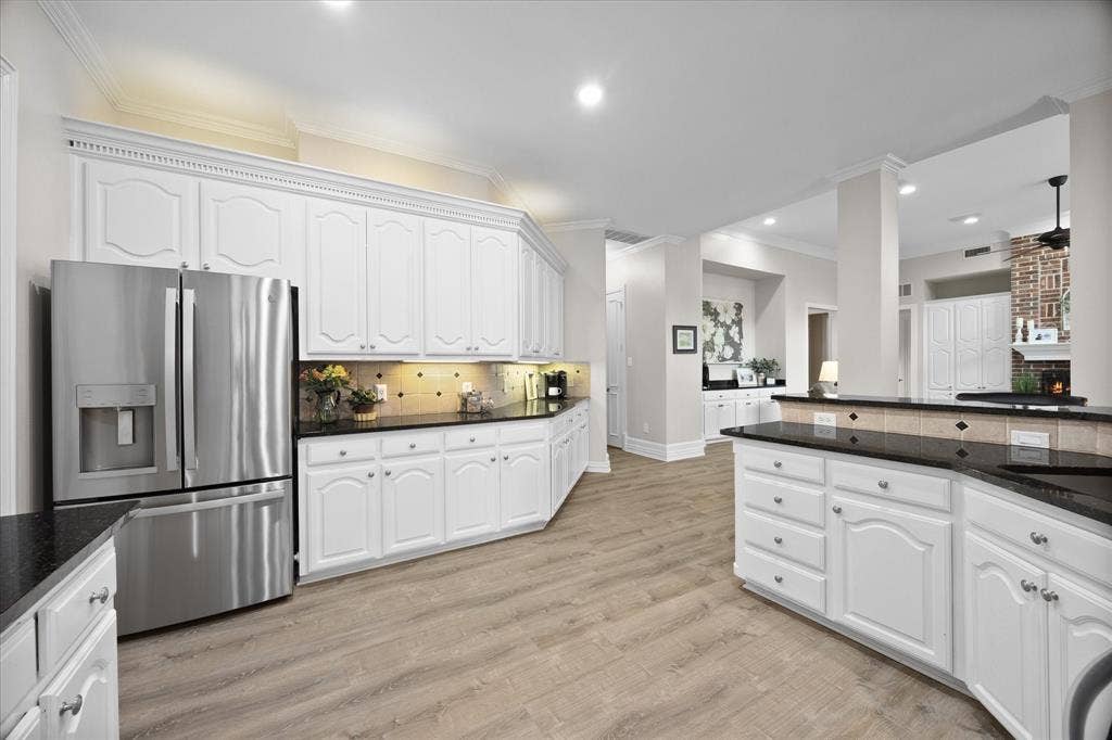 621 Liechty Court, Heath, TX 75032 An abundance of custom cabinetry and countertops is a plus!