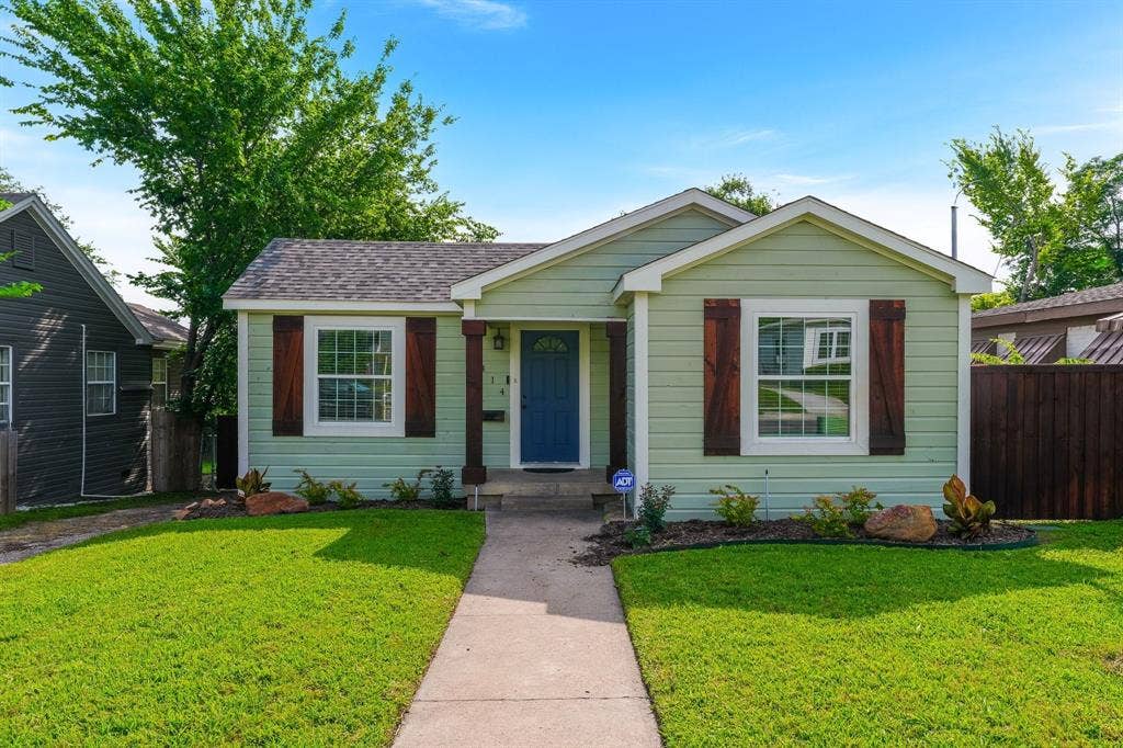 414 Avenue I, Dallas, TX 75203 Green siding exterior with a blue entry door