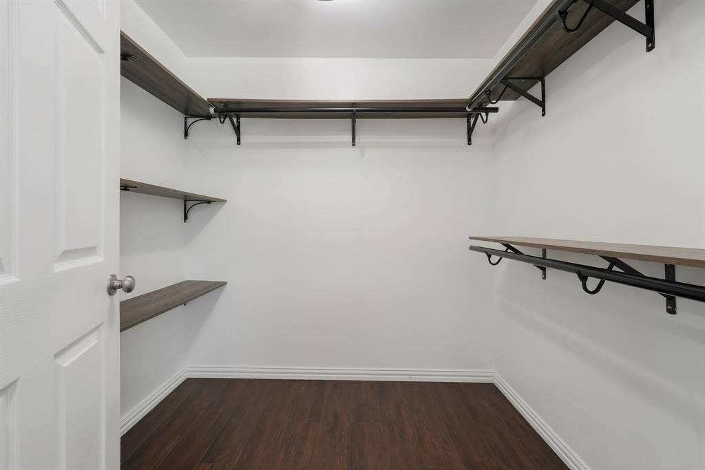 414 Avenue I, Dallas, TX 75203 Spacious walk-in closet featuring white walls, and built-in shelving with hanging rods