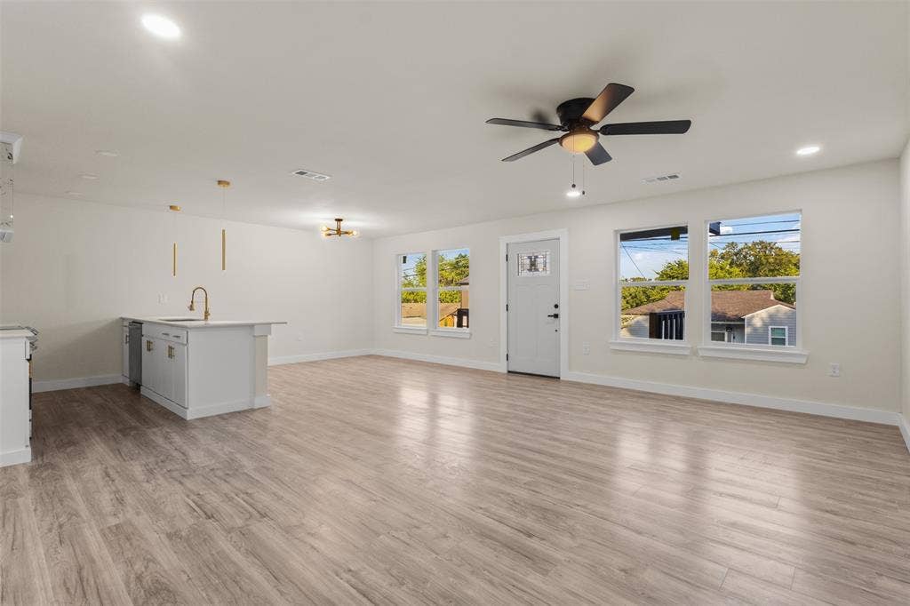 1507 E Waco Avenue, Dallas, TX 75216 Spacious open-concept interior featuring light wood-finish flooring throughout