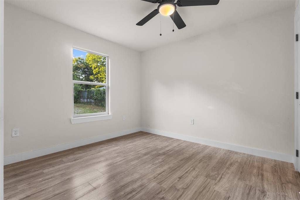 1507 E Waco Avenue, Dallas, TX 75216 Interior room featuring wood-finish flooring and a ceiling fan with integrated lighting