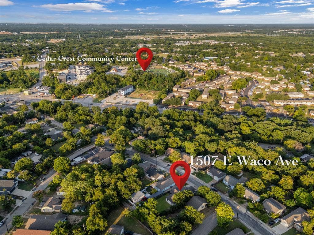 1507 E Waco Avenue, Dallas, TX 75216 Aerial view of a residential neighborhood with dense tree coverage