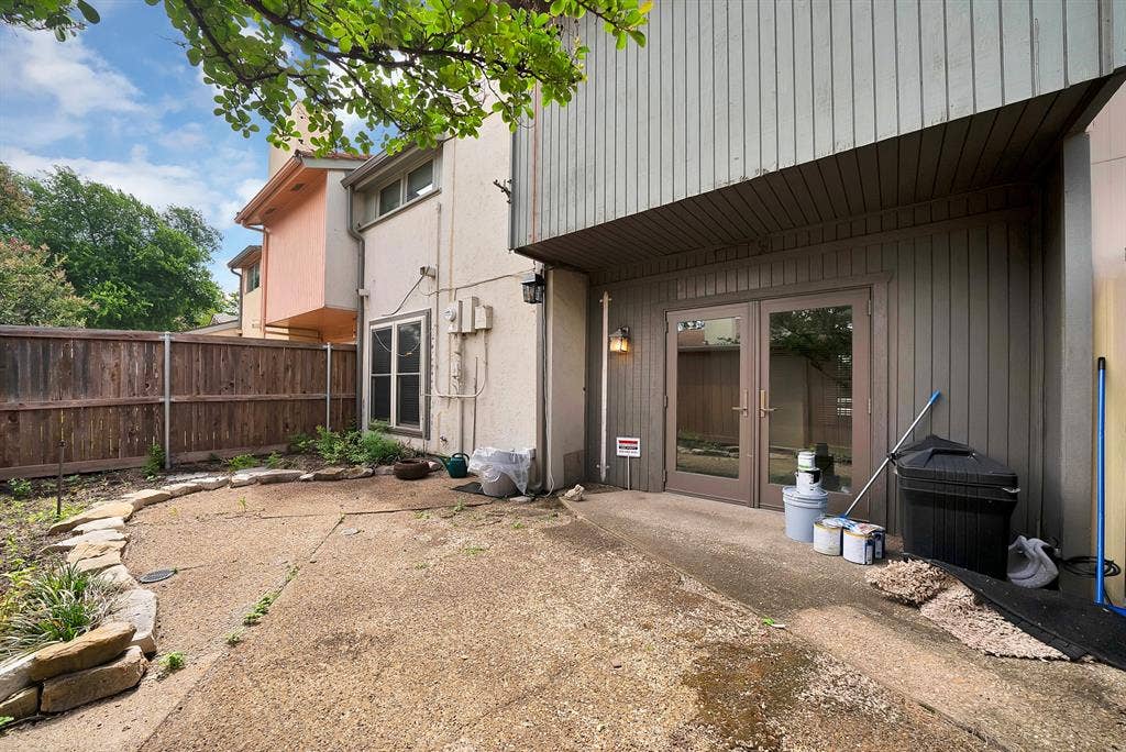 12574 Burninglog Lane, Dallas, TX 75243 Concrete patio area featuring a stone border and wood privacy fencing