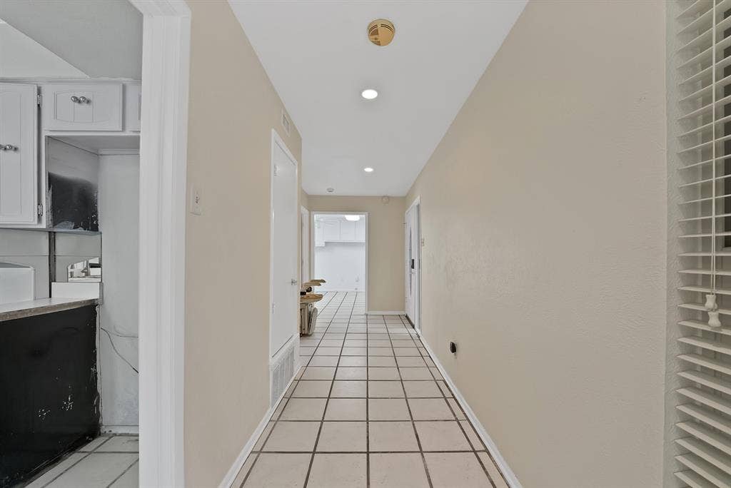 12574 Burninglog Lane, Dallas, TX 75243 Hallway with square tile flooring, recessed lighting, and neutral wall paint