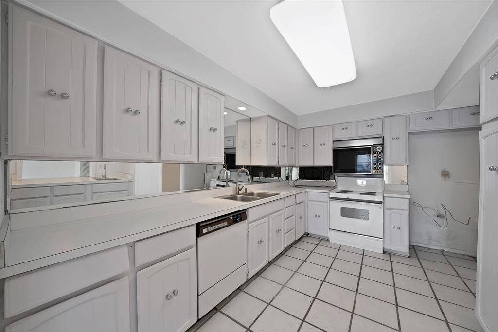 12574 Burninglog Lane, Dallas, TX 75243 Kitchen featuring white cabinetry, integrated appliances, mirrored backsplash, laminate countertops, and tile flooring
