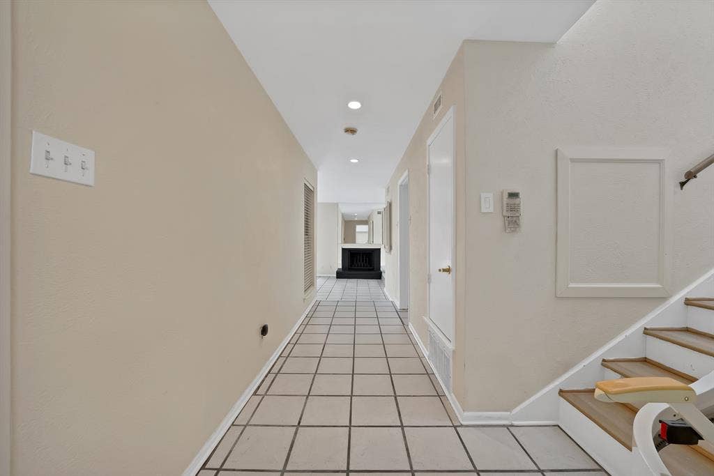 12574 Burninglog Lane, Dallas, TX 75243 Hallway with square tile flooring, recessed lighting, and light neutral wall finishes