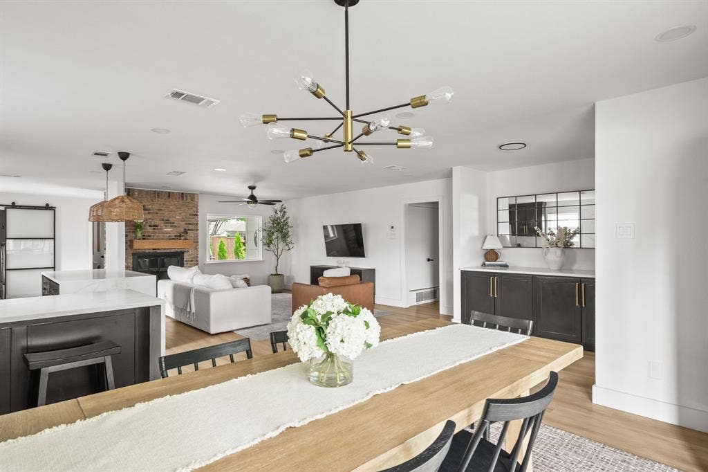 Open-concept dining and living areas featuring wood-finish flooring