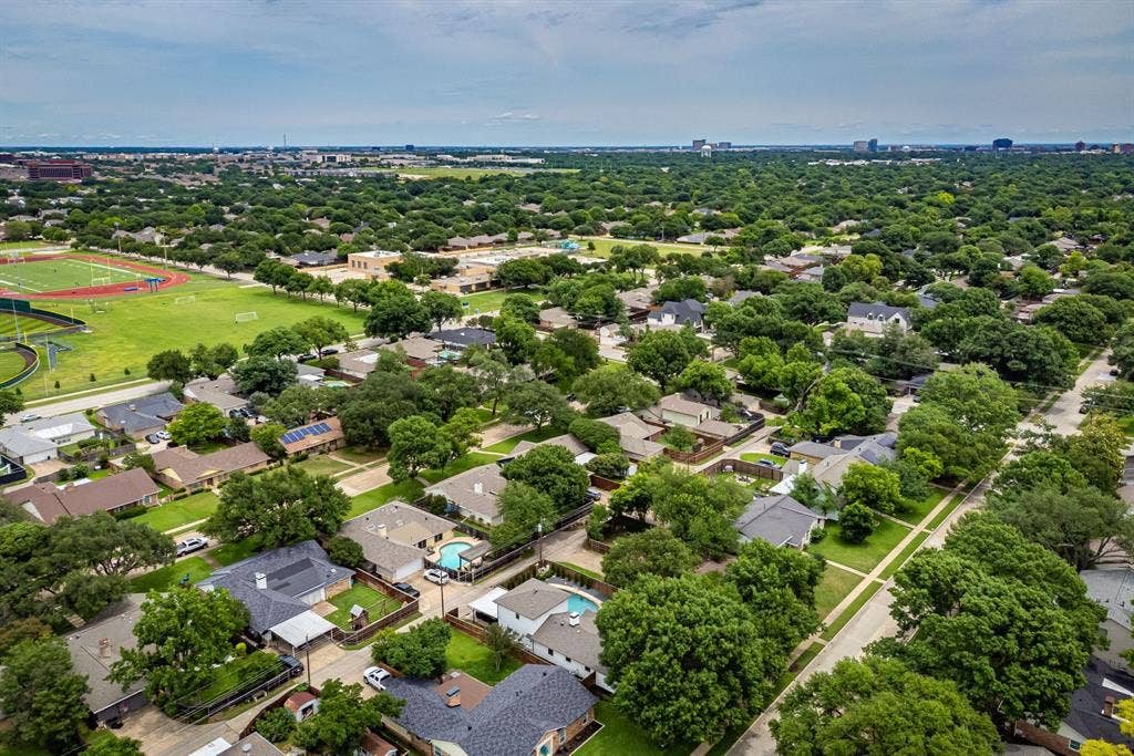 Aerial perspective showcasing a residential area with mature tree canopies