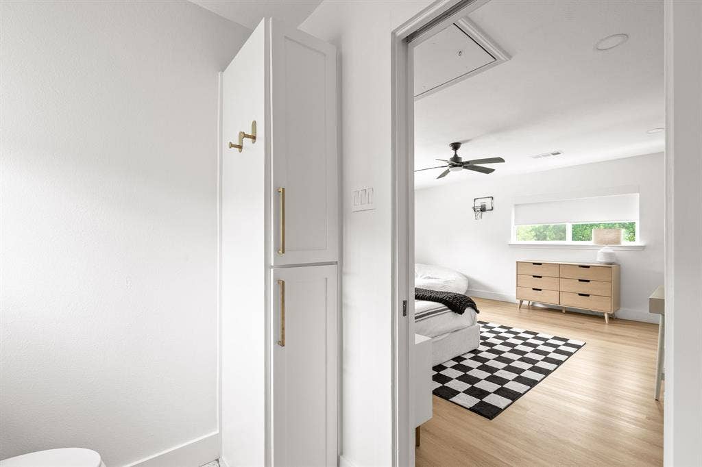 Recessed lighting illuminates wood-finish flooring