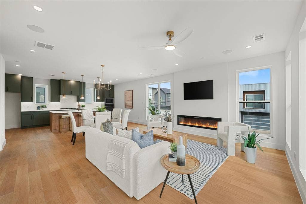 4715 Manett Street, #102, Dallas, TX 75204 Open-concept interior featuring wood-finish flooring, recessed lighting, and a linear electric fireplace
