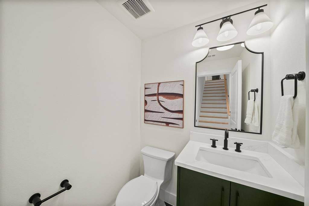 4715 Manett Street, #102, Dallas, TX 75204 Bathroom featuring a custom green vanity with a white countertop and integrated sink