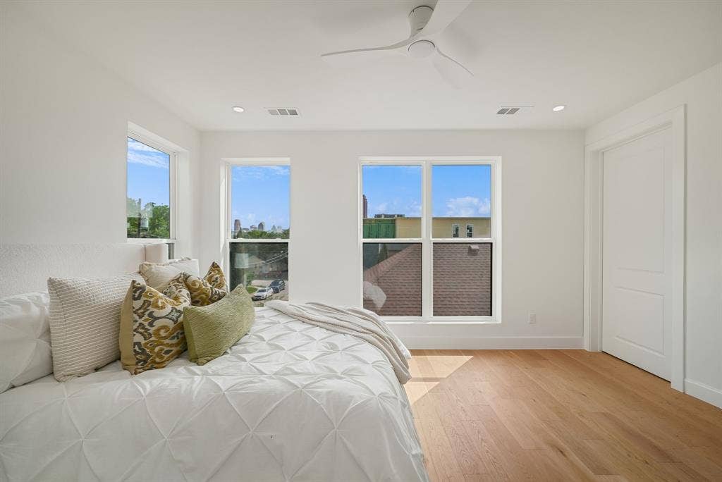 4715 Manett Street, #102, Dallas, TX 75204 Bright bedroom featuring light wood-finish flooring and multiple windows
