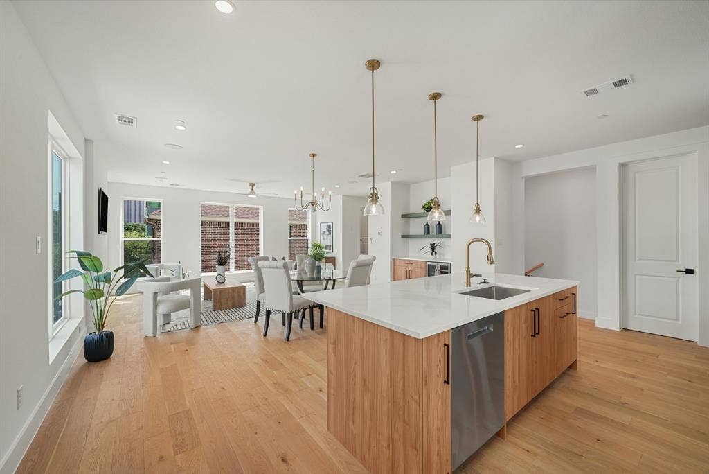 4715 Manett Street, #102, Dallas, TX 75204 Open-concept living area featuring light wood-finish flooring, recessed lighting, and ample natural light from multiple windows
