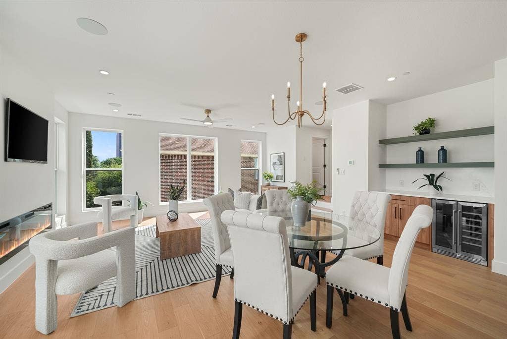 4715 Manett Street, #102, Dallas, TX 75204 Open-concept living area featuring light wood-finish flooring, recessed lighting, and a modern linear fireplace