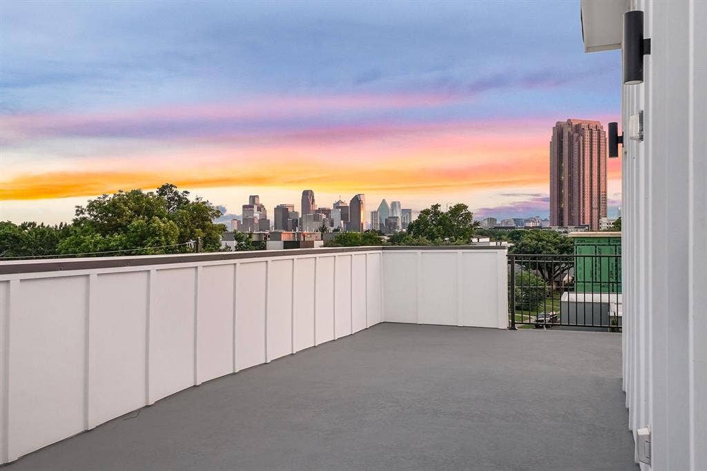 4715 Manett Street, #102, Dallas, TX 75204 Rooftop deck featuring a cityscape backdrop, low-profile perimeter walls, and contemporary exterior lighting fixtures