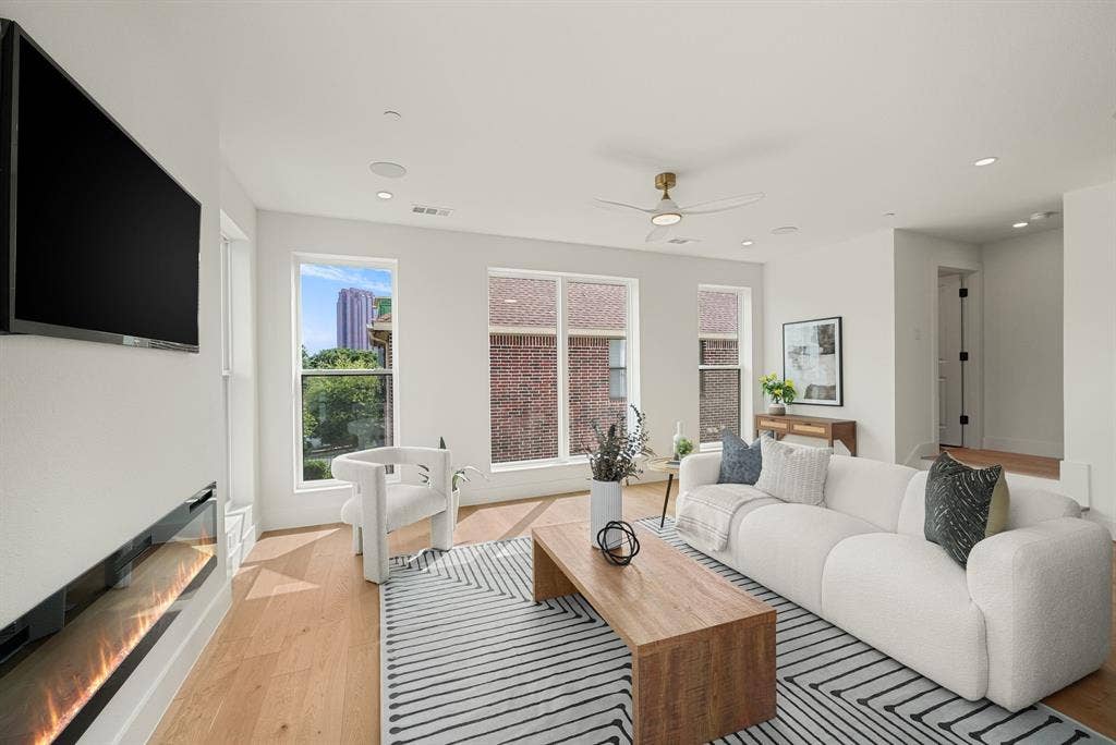 4715 Manett Street, #102, Dallas, TX 75204 Spacious living area featuring light wood-finish flooring, recessed lighting, and large windows