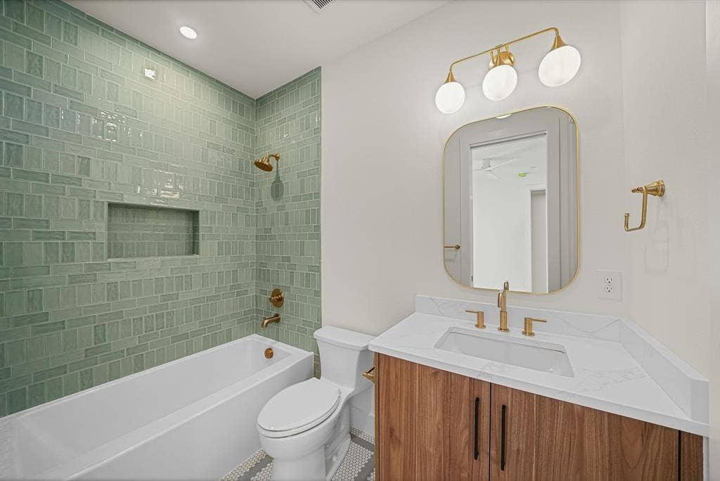 4715 Manett Street, #102, Dallas, TX 75204 Bathroom featuring a tub/shower combination with green subway tile surround and integrated niche