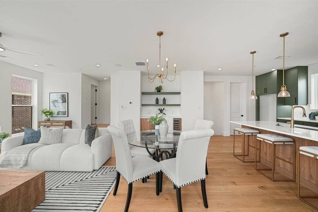 4715 Manett Street, #102, Dallas, TX 75204 Spacious open-concept living area featuring light wood-finish flooring, recessed lighting, and white walls
