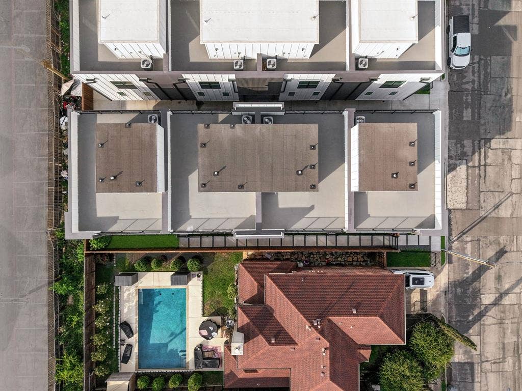 4715 Manett Street, #102, Dallas, TX 75204 Aerial perspective showcasing a modern multi-unit building with rooftop terraces