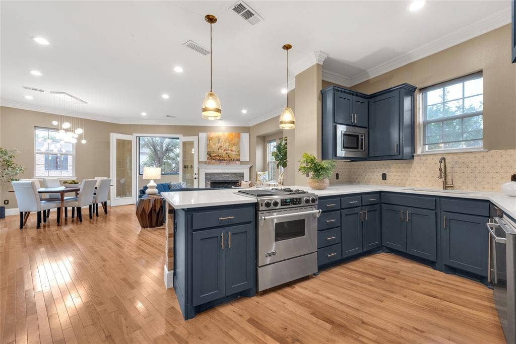 5102 Ridgedale Avenue, Dallas, TX 75206 Open-concept kitchen featuring shaker-style cabinetry, a built-in microwave, and stainless steel appliances