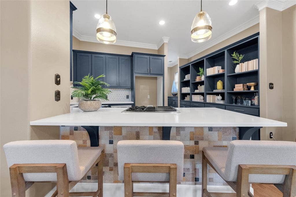 5102 Ridgedale Avenue, Dallas, TX 75206 Kitchen island with a white countertop and integrated cooktop