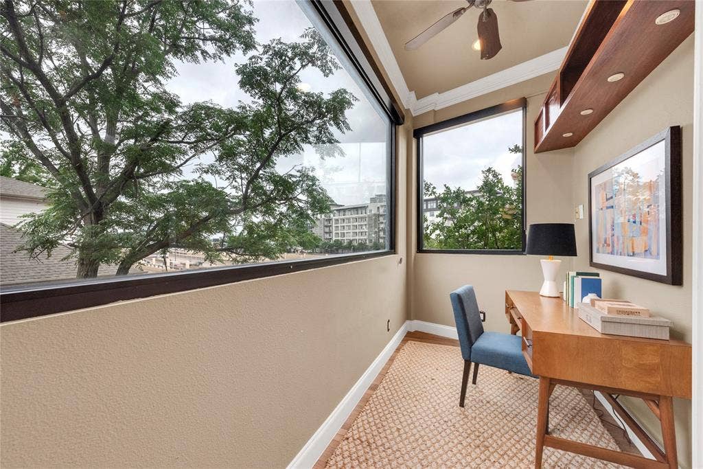 5102 Ridgedale Avenue, Dallas, TX 75206 Dedicated office space featuring large windows, wood-finish flooring, built-in shelving with integrated lighting, a ceiling fan, and crown molding