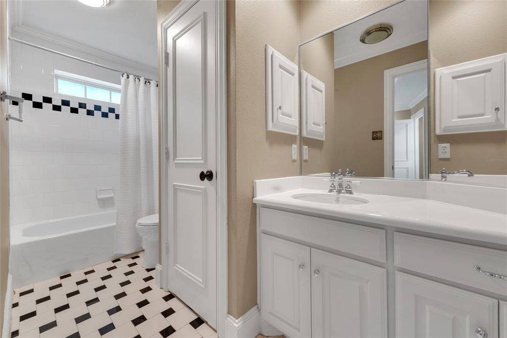 5102 Ridgedale Avenue, Dallas, TX 75206 Bathroom featuring a white vanity with an integrated sink, polished chrome faucet, and a large mirror