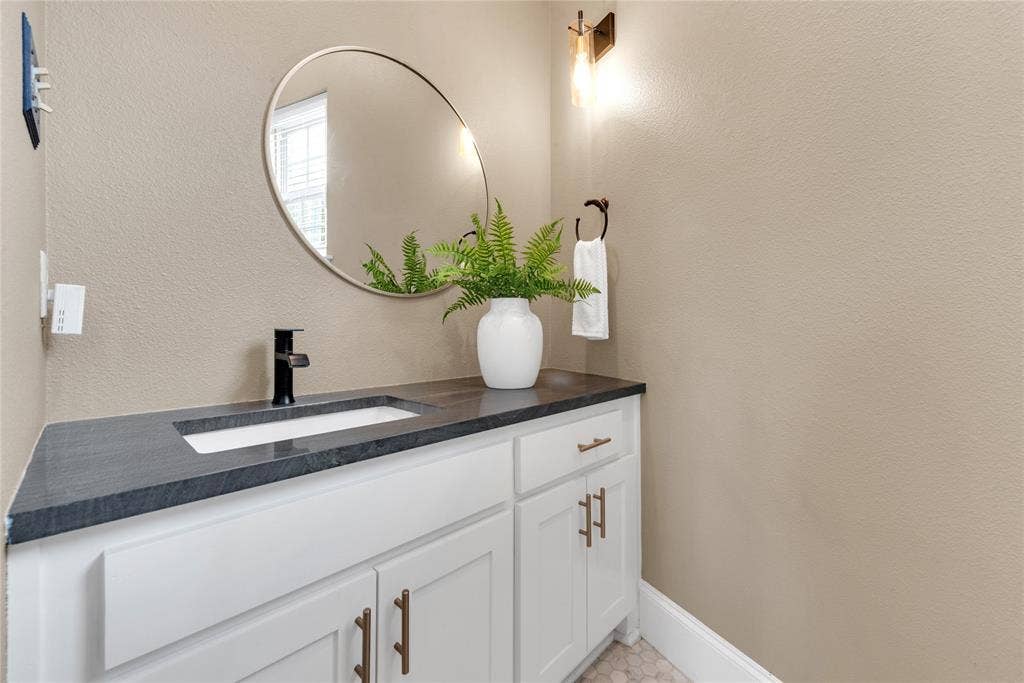 5102 Ridgedale Avenue, Dallas, TX 75206 Vanity featuring a dark countertop, integrated rectangular sink, and matte black faucet