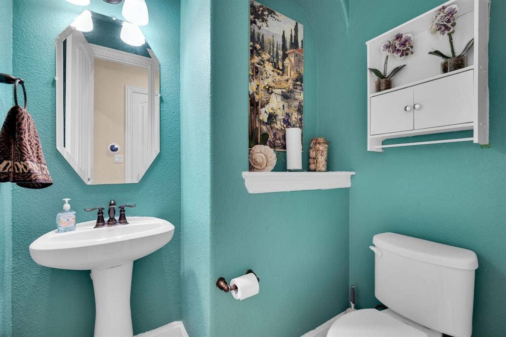 Downstairs half bath with pedestal sink.