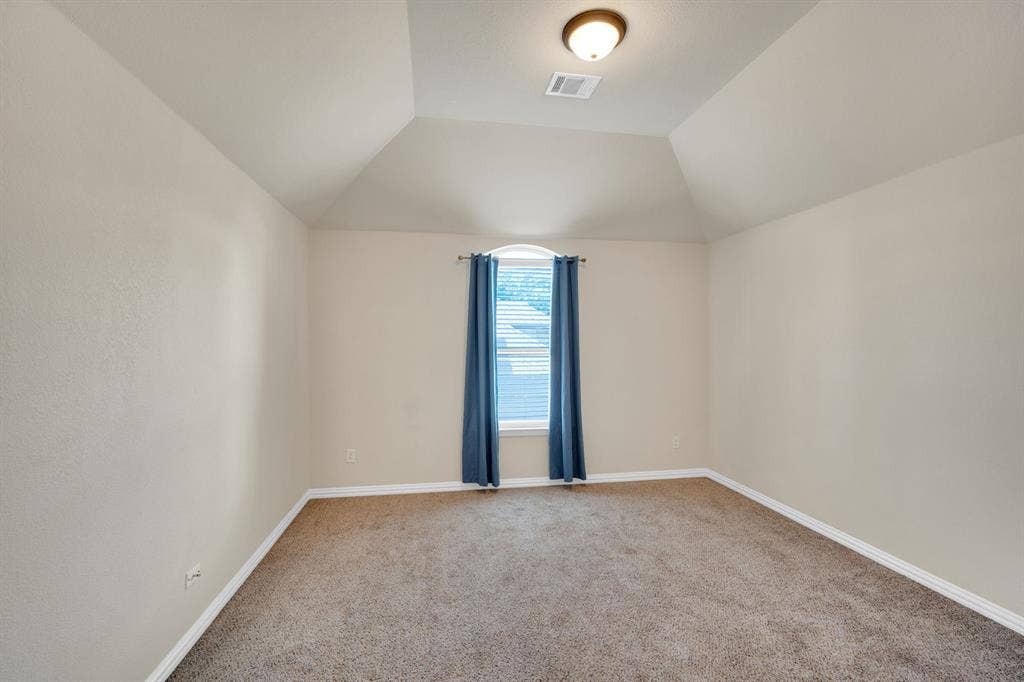 1st Upstairs guest bedroom with tall ceilings and natural light.
