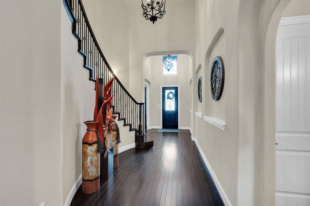 View of the grand entryway showing off the cascading staircase and art niches.