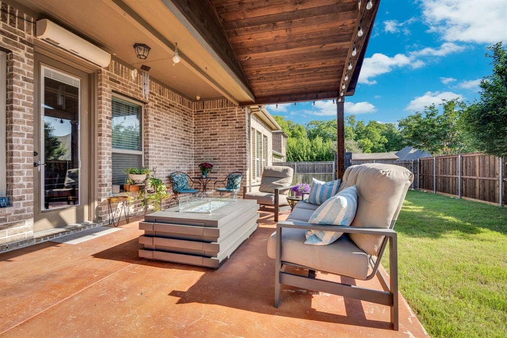Outdoor living space with pergola and outdoor lighting.
