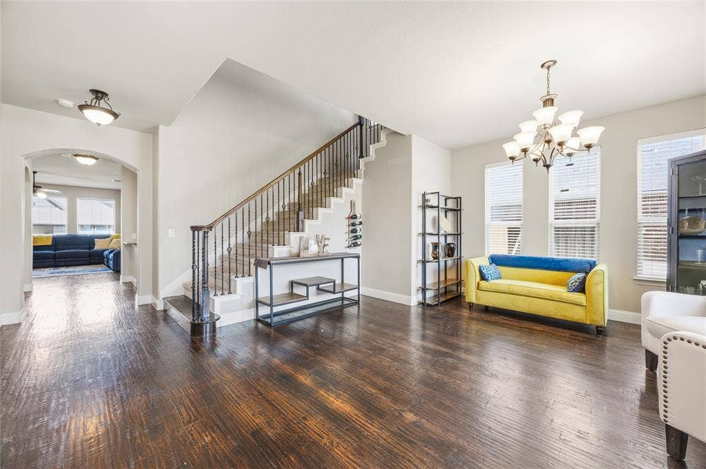 1133 Vickery Drive, DeSoto, TX 75115 Open the front door to a spacious common area featuring wood-finish flooring, ample natural light from multiple windows, a prominent arched window. This is a sight to see.