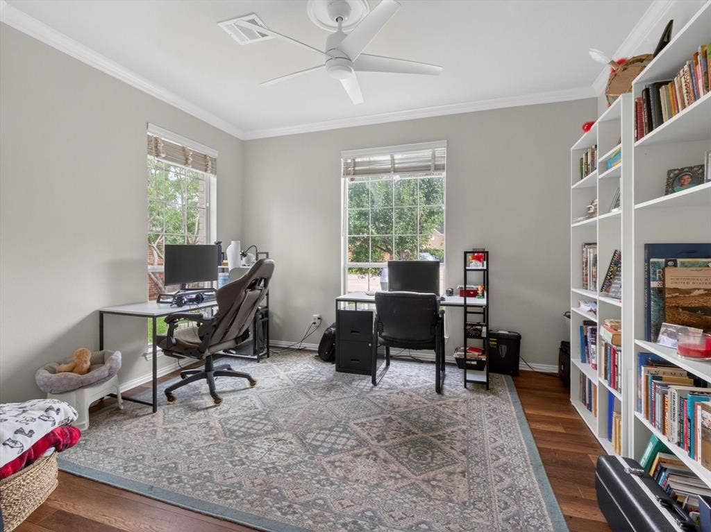 1712 Tealwood Lane, Corinth, TX 76210 Spacious room featuring two large windows, hardwood flooring, and neutral wall tones