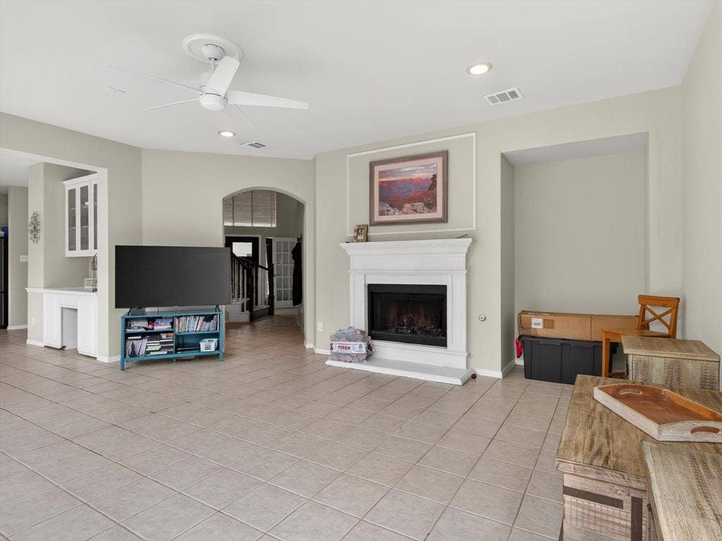 1712 Tealwood Lane, Corinth, TX 76210 Spacious living area featuring light-toned tile flooring, recessed lighting, and a modern ceiling fan