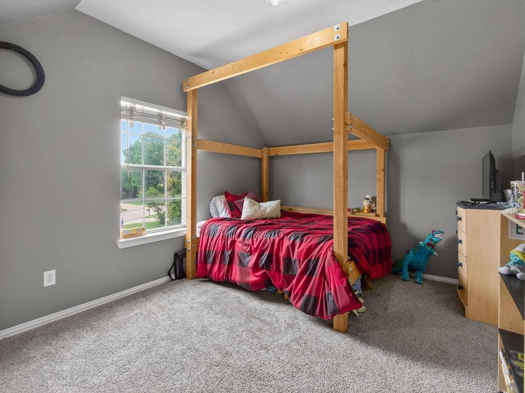 1712 Tealwood Lane, Corinth, TX 76210 Room featuring sloped ceilings, light gray wall paint, and gray carpet flooring