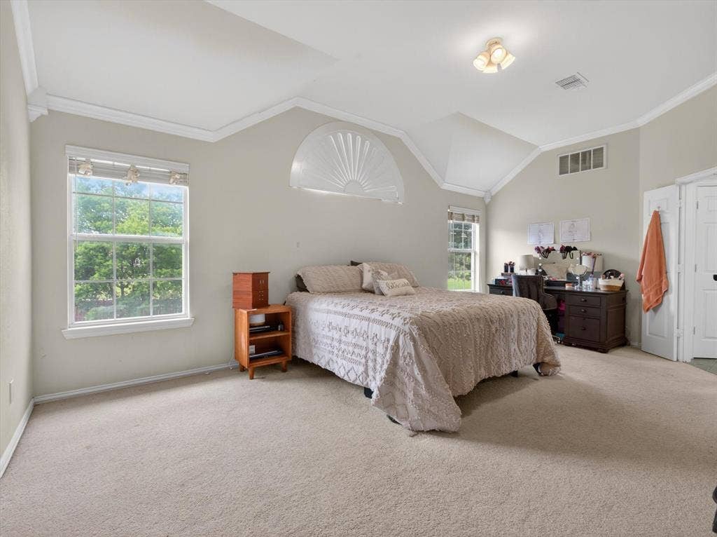 1712 Tealwood Lane, Corinth, TX 76210 Carpeted room featuring a vaulted ceiling with crown molding and an integrated ceiling fan light fixture