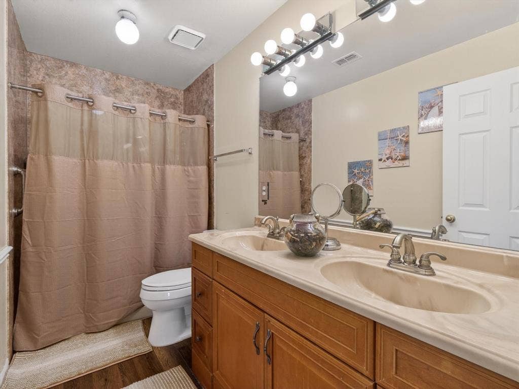 1712 Tealwood Lane, Corinth, TX 76210 Double vanity with integrated sinks and a large mirror